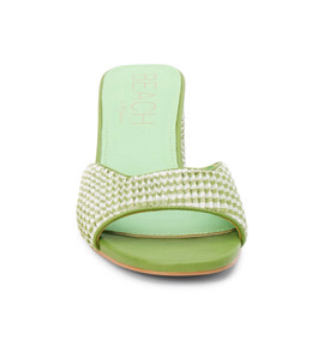 Green woven sandal with a block heel front