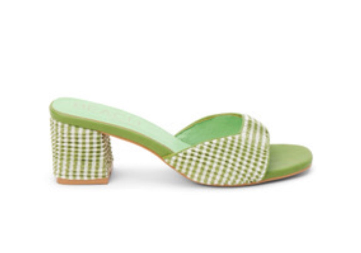 Green woven sandal with a block heel close-up