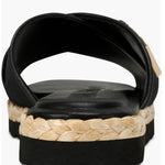 Black slide sandal with gold logo and woven strap heel