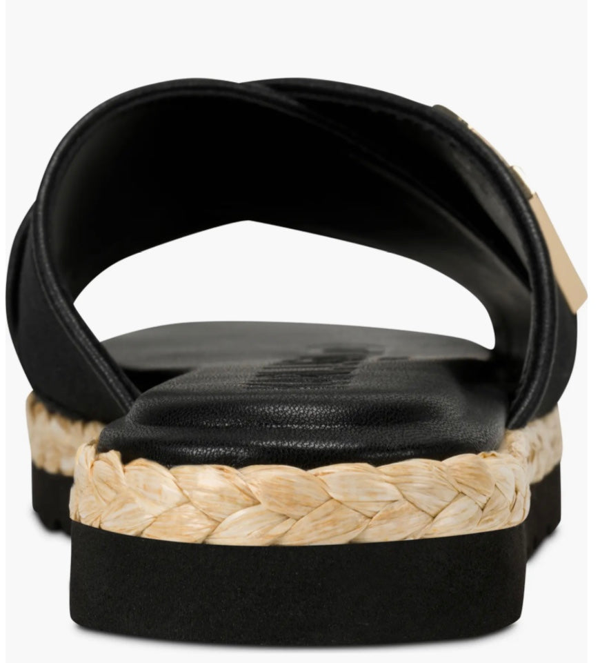 Black slide sandal with gold logo and woven strap heel