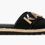 Black slide sandal with gold logo and woven strap close-up