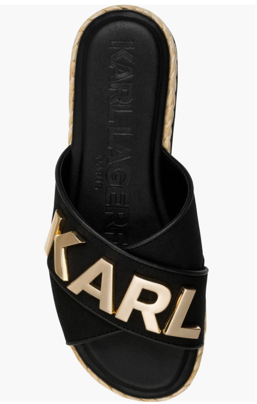 Black slide sandal with gold logo and woven strap top