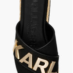 Black slide sandal with gold logo and woven strap top