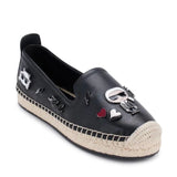 Black flat moccasin-styled shoe with decorative elements side