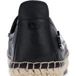 Black flat moccasin-styled shoe with decorative elements heel