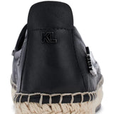 Black flat moccasin-styled shoe with decorative elements heel