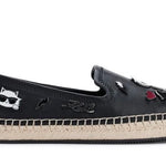 Black flat moccasin-styled shoe with decorative elements 