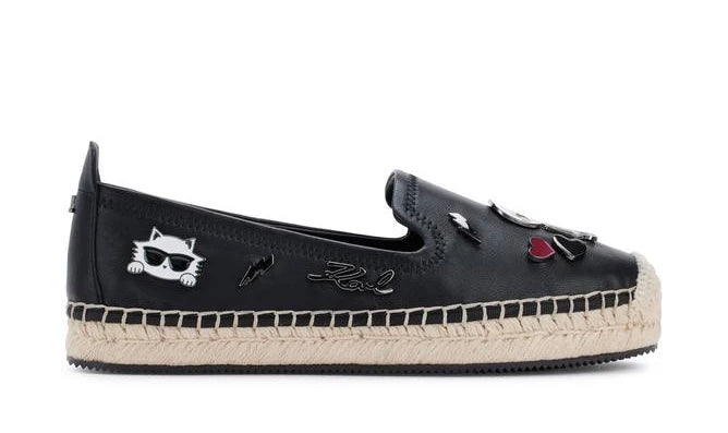 Black flat moccasin-styled shoe with decorative elements 