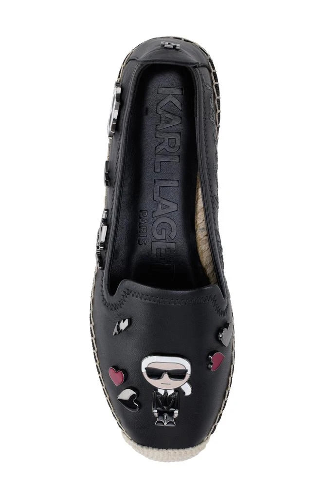 Black flat moccasin-styled shoe with decorative elements top