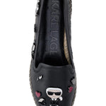 Black flat moccasin-styled shoe with decorative elements top
