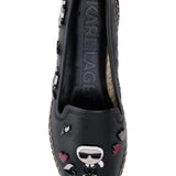 Black flat moccasin-styled shoe with decorative elements top