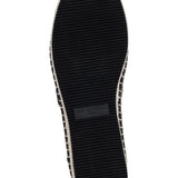 Black flat moccasin-styled shoe with decorative elements sole