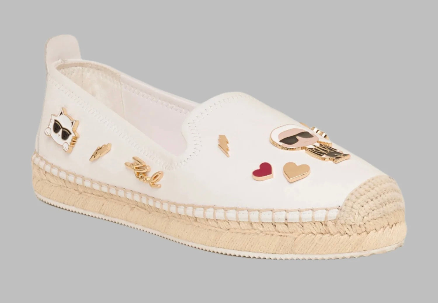 White flat moccasin-styled shoe with decorative elements side 2