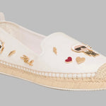White flat moccasin-styled shoe with decorative elements side 2