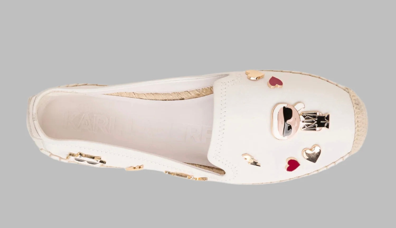 White flat moccasin-styled shoe with decorative elements top