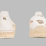 White flat moccasin-styled shoe with decorative elements alt view