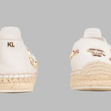 White flat moccasin-styled shoe with decorative elements alt view
