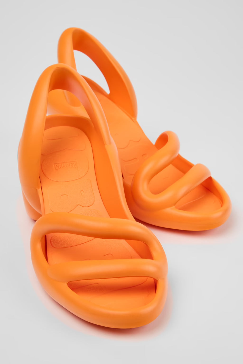Orange high-heeled shoe pair