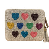 Beige pouch with colorful heart patterns and a tassel on a white background