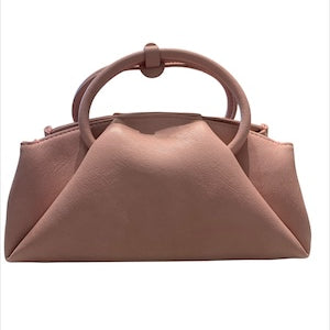 Pink handbag with circular handle close-up