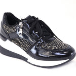 Black sneaker with rhinestone details on a white background