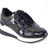 Black sneaker with rhinestone details on a white background