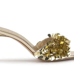 Gold high-heeled shoe with gold sequin embellishments close-up