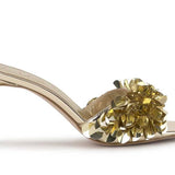 Gold high-heeled shoe with gold sequin embellishments close-up