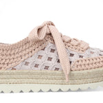 Pink woven sneaker with textured sole close-up