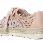Pink woven sneaker with textured sole heel view