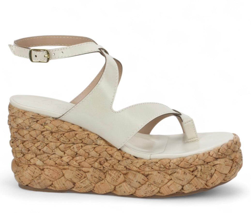White sandal with a cork wedge sole close-up