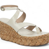 White sandal with a cork wedge sole side view
