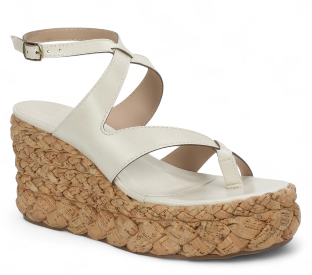 White sandal with a cork wedge sole side view