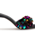 Black high-heeled shoe with colorful floral sequin embellishments close-up