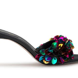 Black high-heeled shoe with colorful floral sequin embellishments close-up