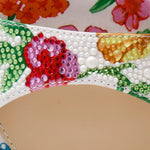 Colorful floral-patterned heel with buckle closure close-up