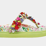 Colorful floral sandal with a green sole close-up
