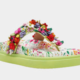 Colorful floral sandal with a green sole front