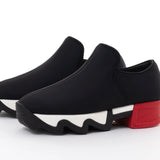 Black slip-on shoe with a red heel and black & white sole pair