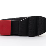 Black slip-on shoe with a red heel and black & white sole sole view
