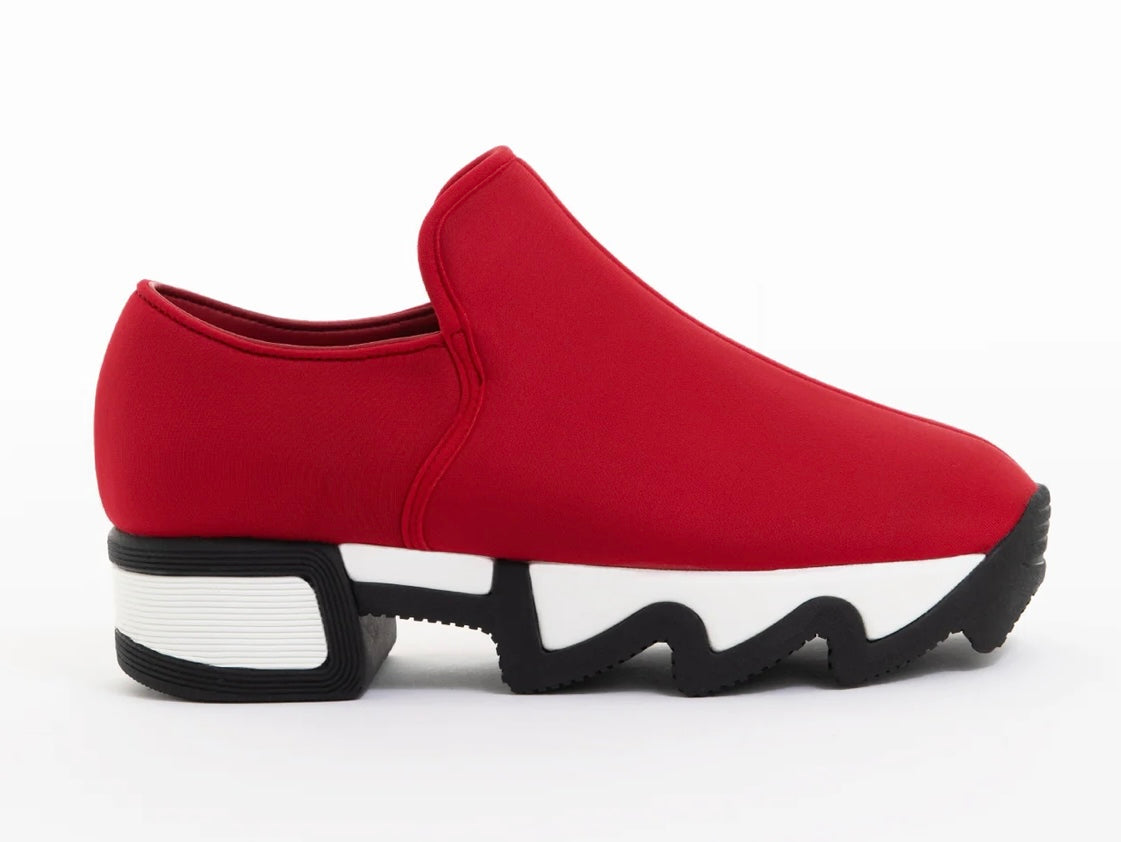 Red slip-on shoe with black & white sole close-up