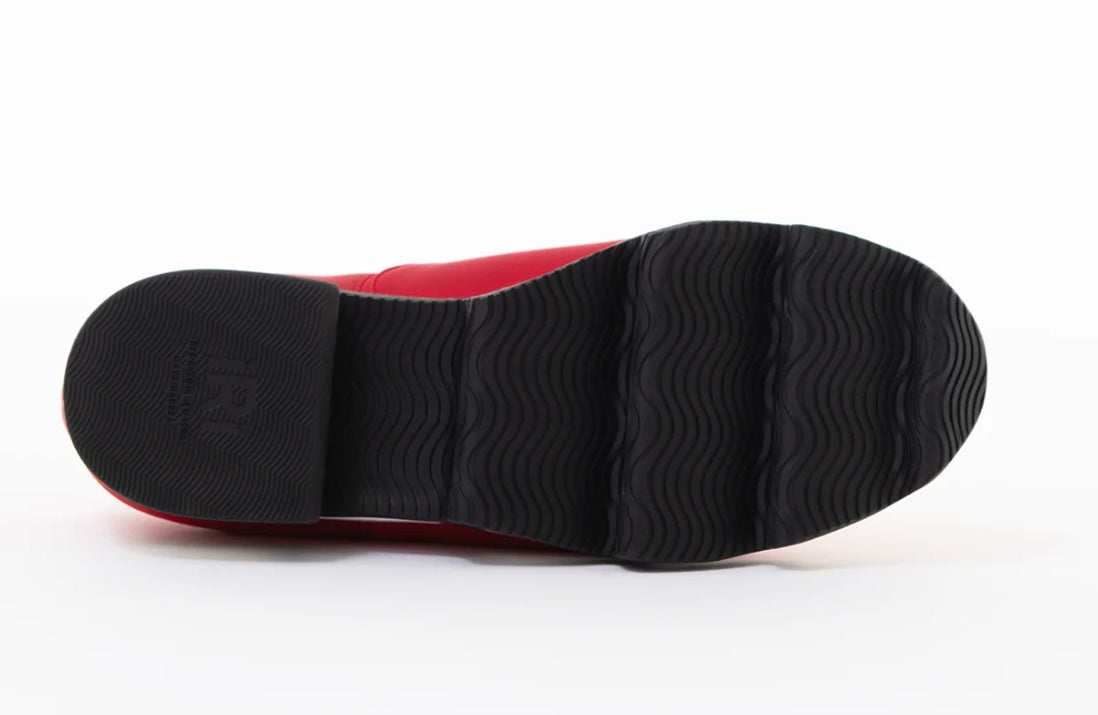 Red slip-on shoe with black & white sole sole view