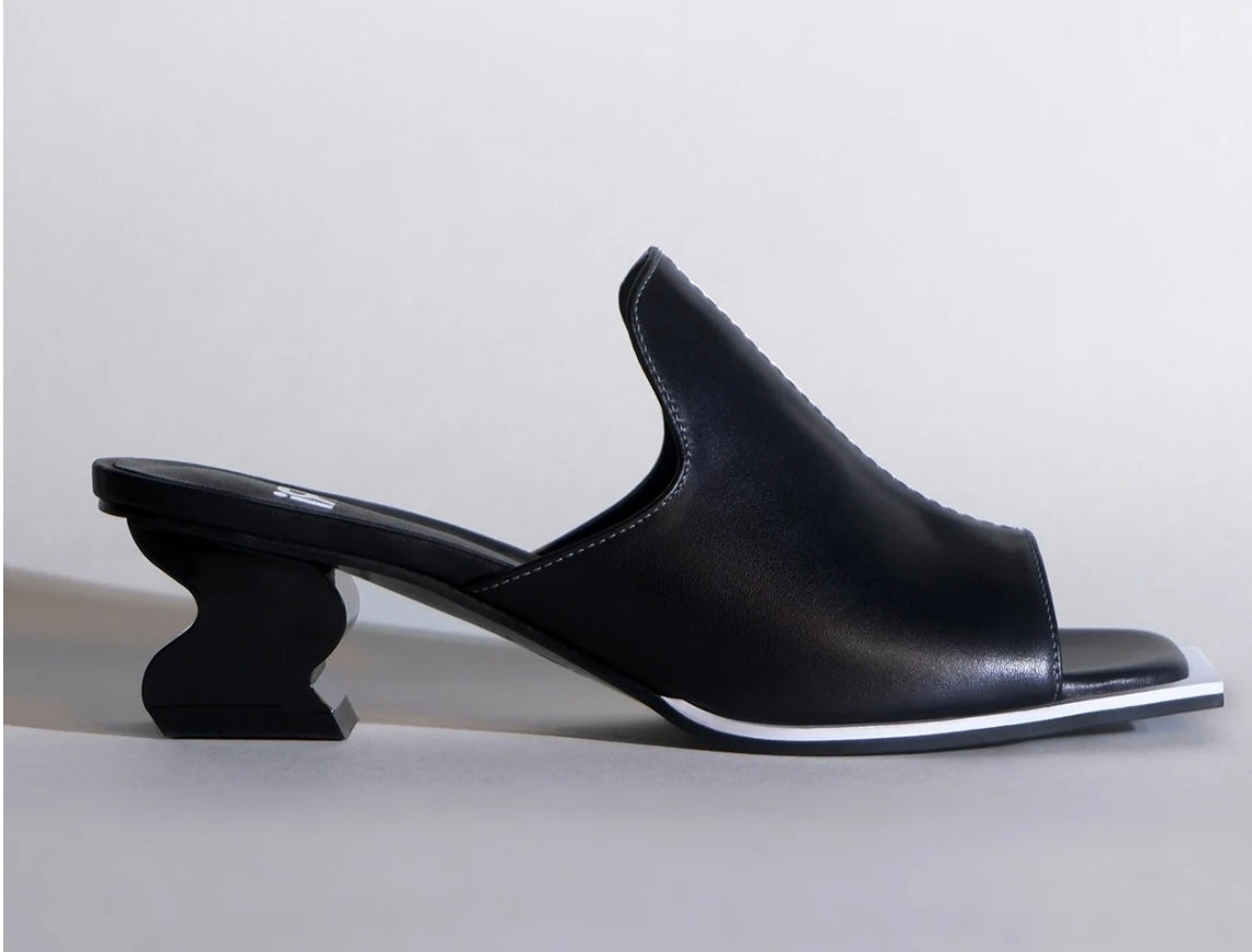 Black & white open-toe shoe with a unique heel design close-up
