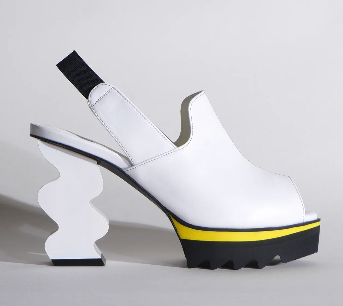 White heel with black & yellow sole close-up