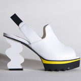 White heel with black & yellow sole close-up