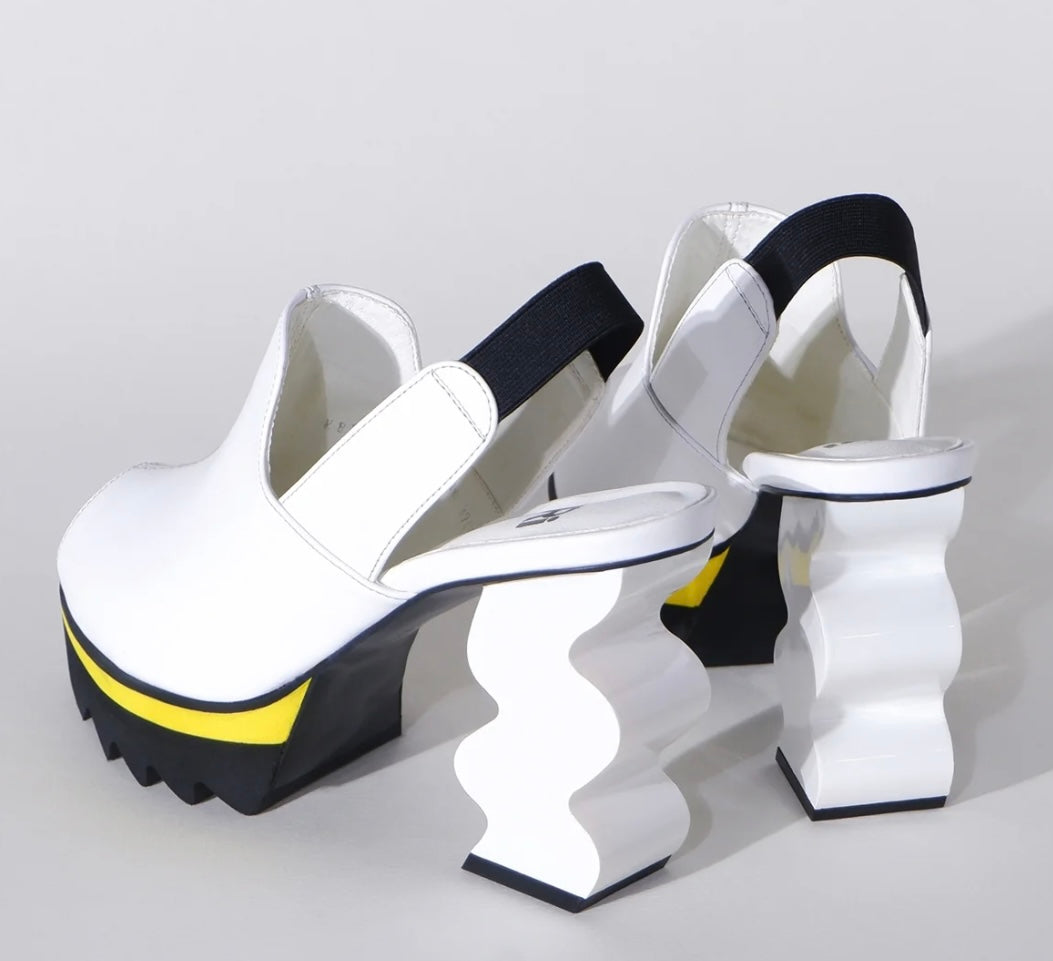 White heel with black & yellow sole heel view