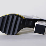 White heel with black & yellow sole sole view