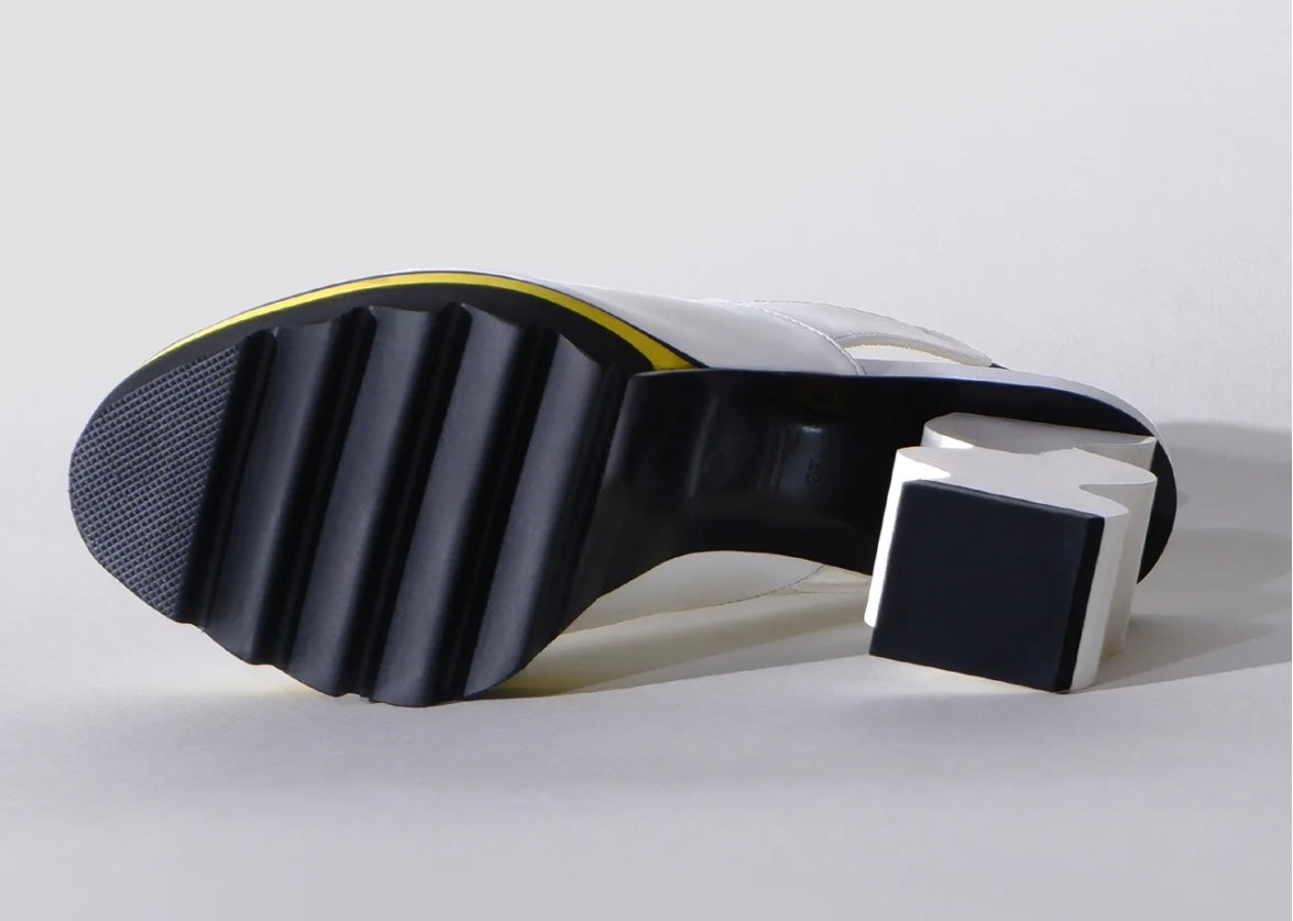 White heel with black & yellow sole sole view