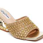 Gold embellished high-heeled shoe front view