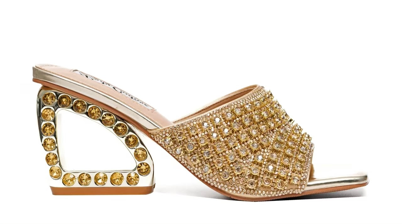 Gold embellished high-heeled shoe close-up